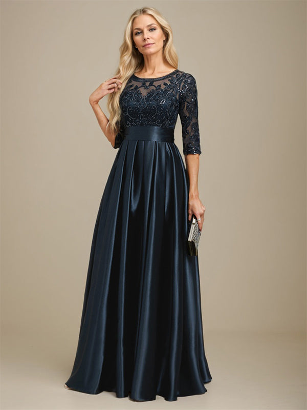 Vestido de mãe da noiva em cetim stretch com renda, comprimento até o chão, corte evasê, decote redondo com ilusão e laço com paetês