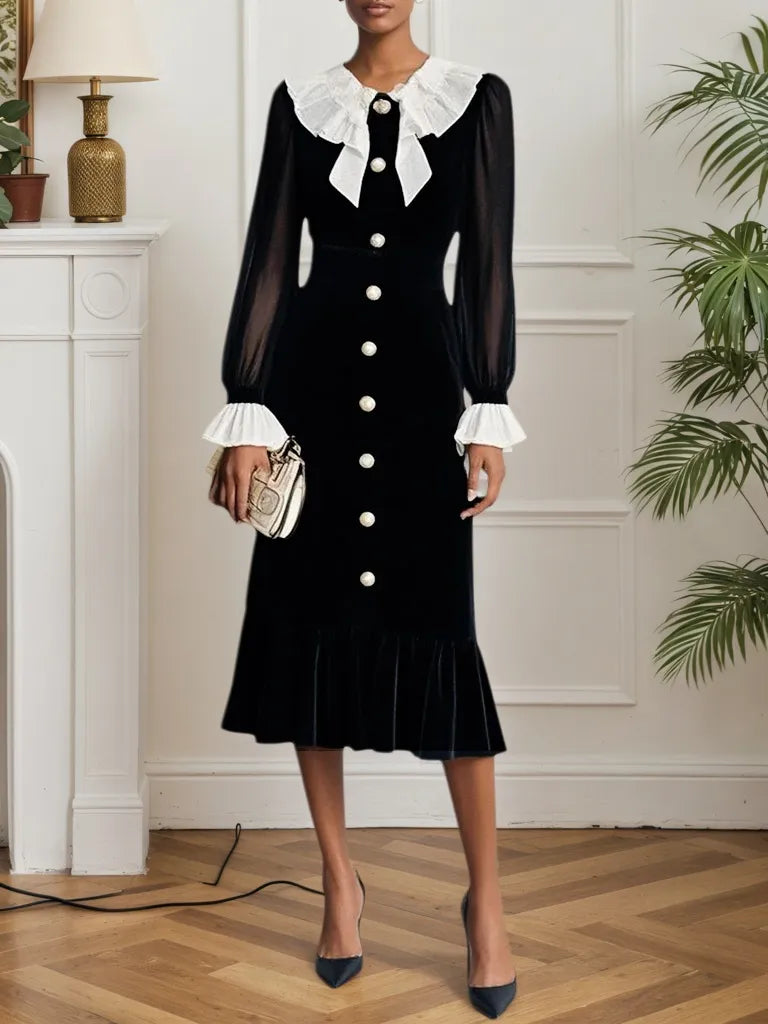 Vestido midi de terciopelo negro con volantes y abertura, estilo sirena