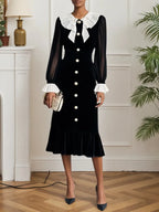 Vestido midi de terciopelo negro con volantes y abertura, estilo sirena