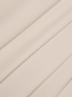 Abito lungo plissettato a linea A color avorio con maniche a tre quarti arricciate