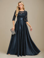 Vestido de mãe da noiva em cetim stretch com renda, comprimento até o chão, corte evasê, decote redondo com ilusão e laço com paetês