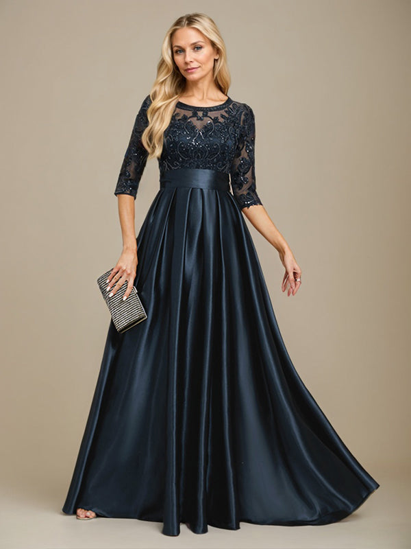 Vestido de mãe da noiva em cetim stretch com renda, comprimento até o chão, corte evasê, decote redondo com ilusão e laço com paetês
