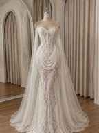 Romantic Transparent Lace Mermaid Wedding Gown Featuring Beaded Drape And Long Floating Tulle Cape Sleeves