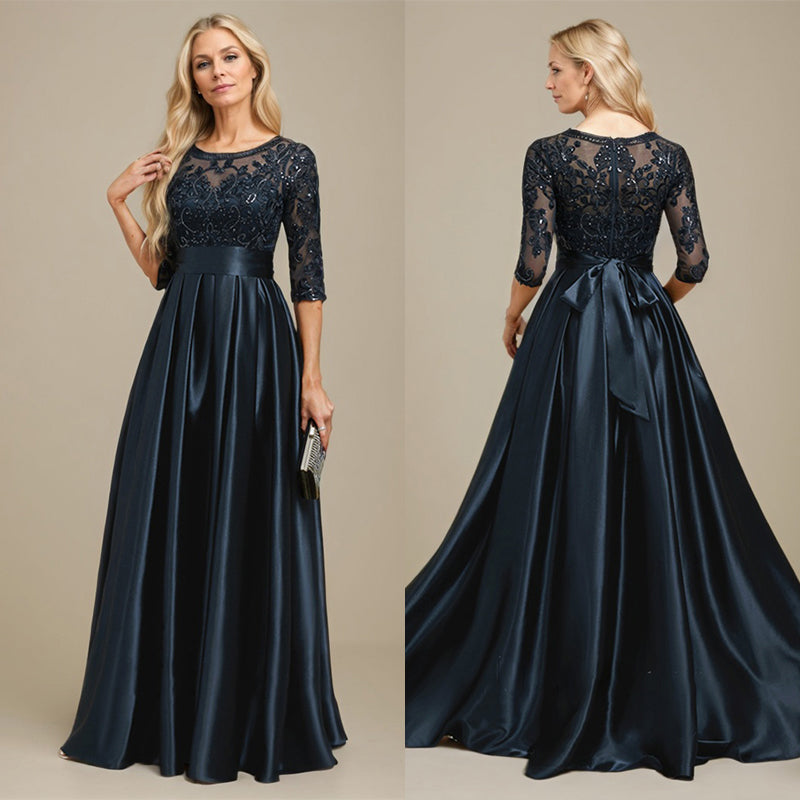 Vestido de mãe da noiva em cetim stretch com renda, comprimento até o chão, corte evasê, decote redondo com ilusão e laço com paetês
