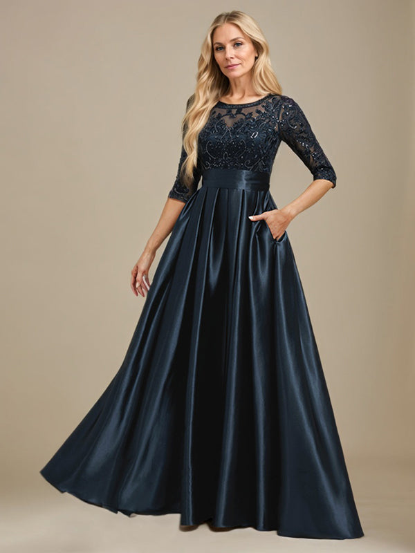 Vestido de mãe da noiva em cetim stretch com renda, comprimento até o chão, corte evasê, decote redondo com ilusão e laço com paetês
